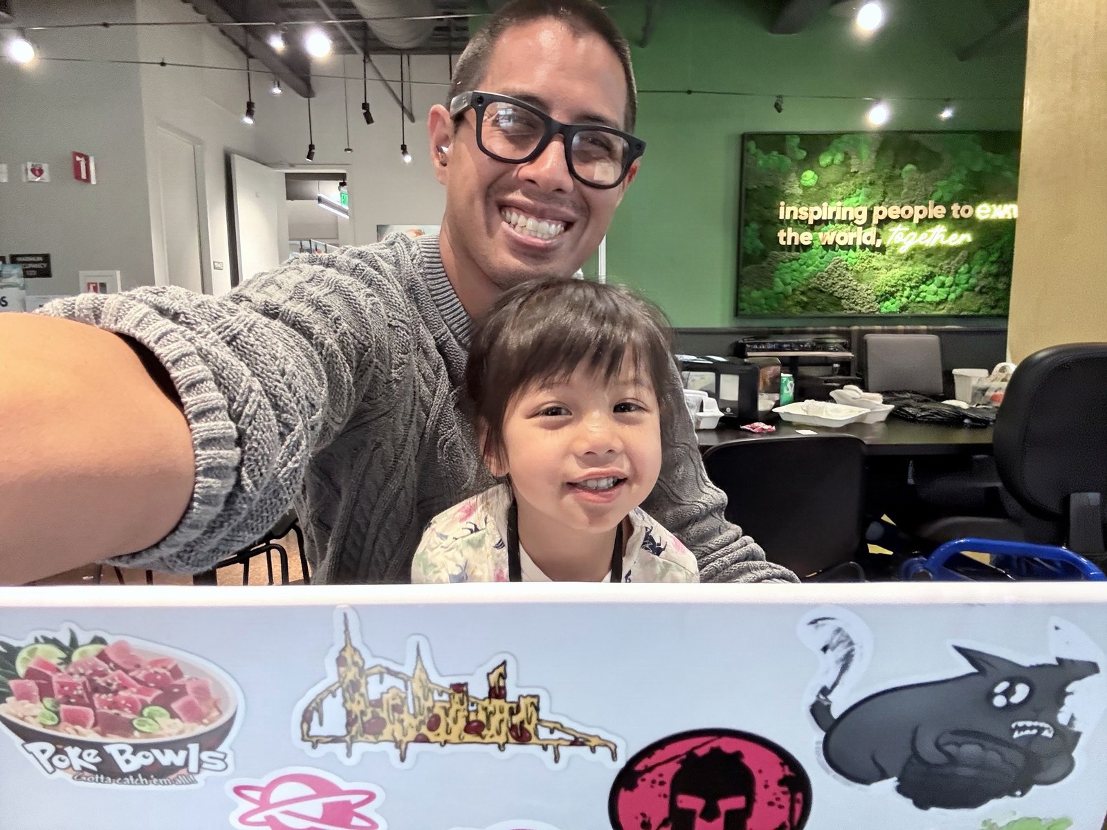 James Prompanya smiling for a photo with a child